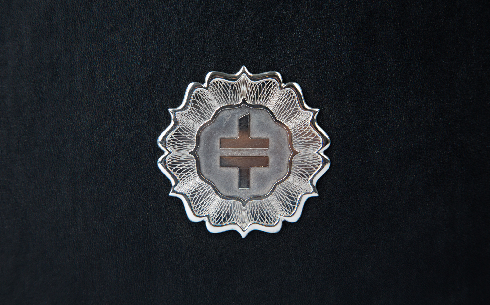 A Double Cross Vodka brand silver emblem design on a black background.