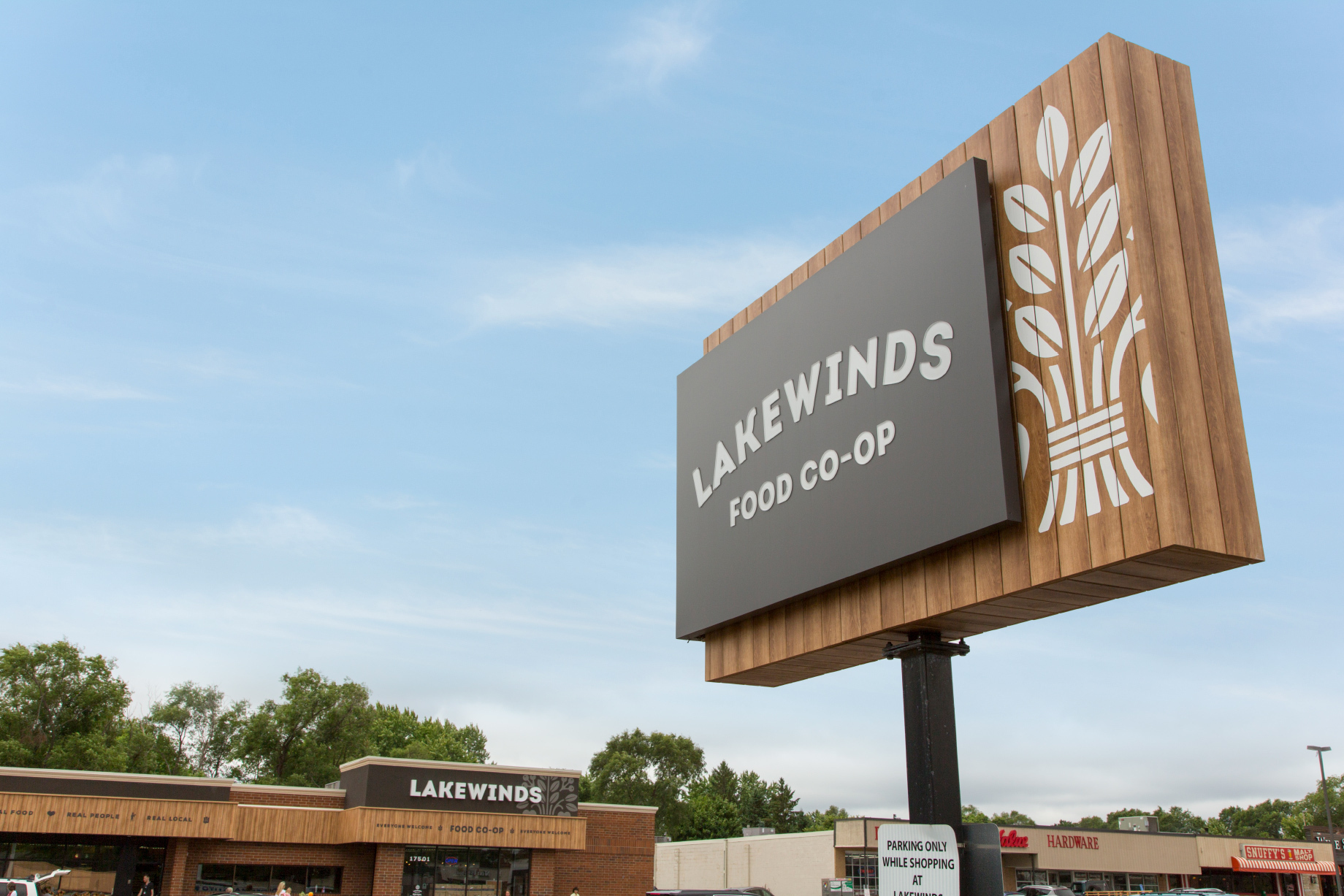 The Lakewinds retail brand design signage for natural and organic food store with blue sky.